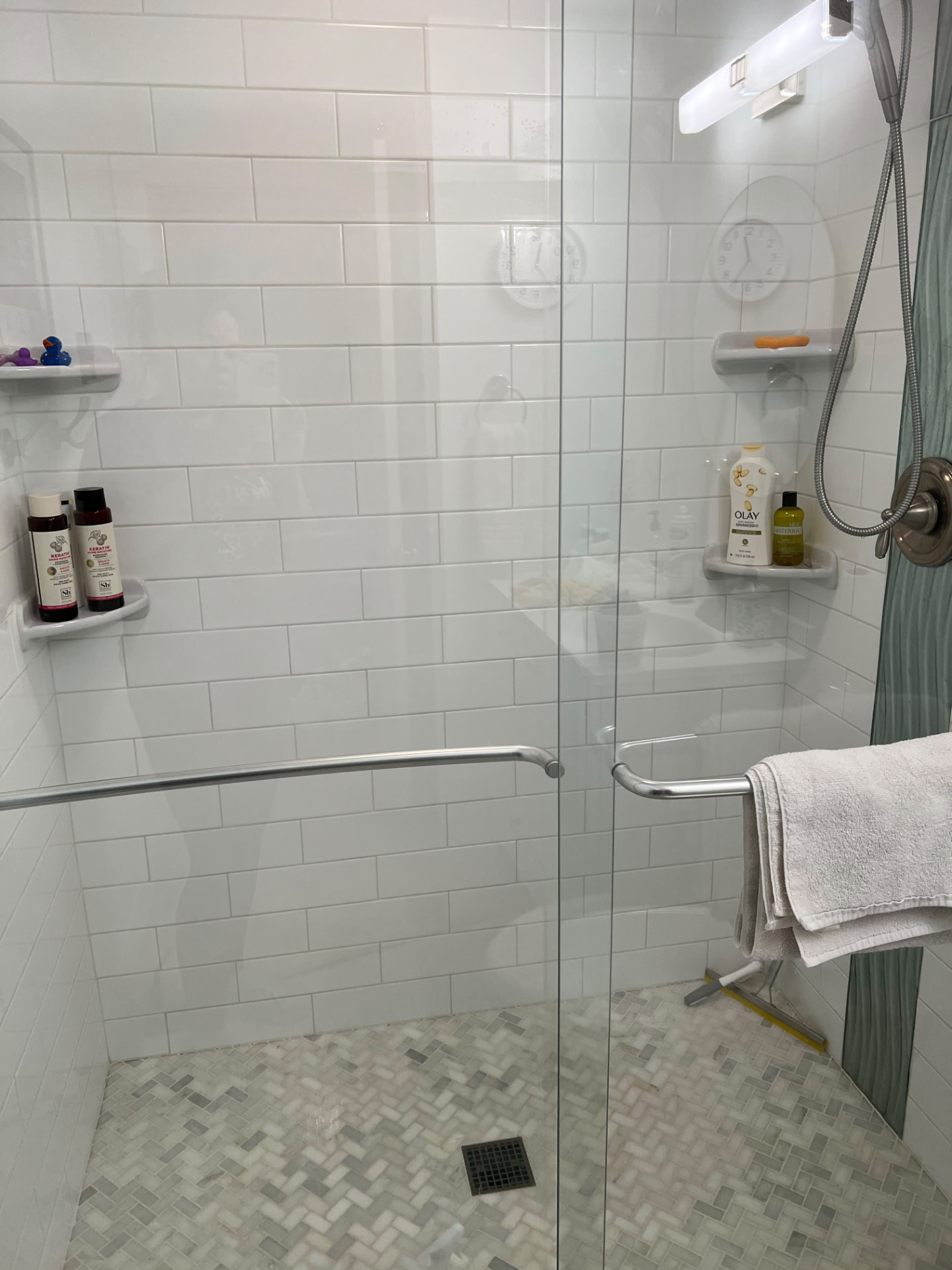 Subway-tile shower — gleaming fixtures & glass by MD Cleaning Services LLC