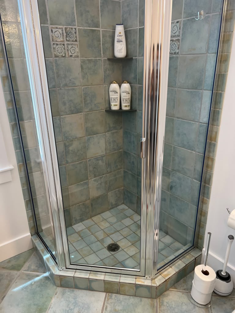 Corner shower — streak-free glass, polished chrome by MD Cleaning Services LLC